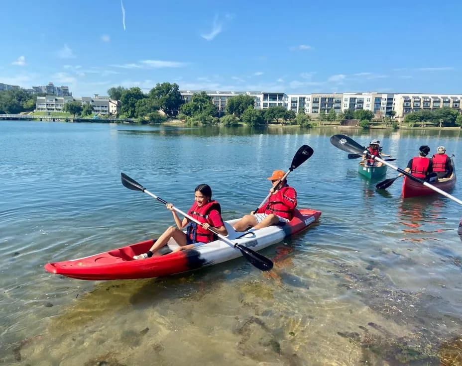 a group of people rowing a boat
