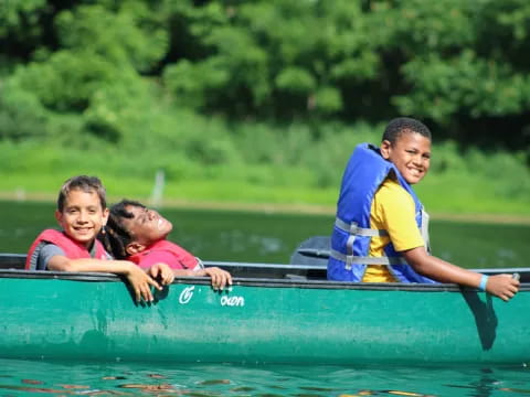 a group of kids in a canoe