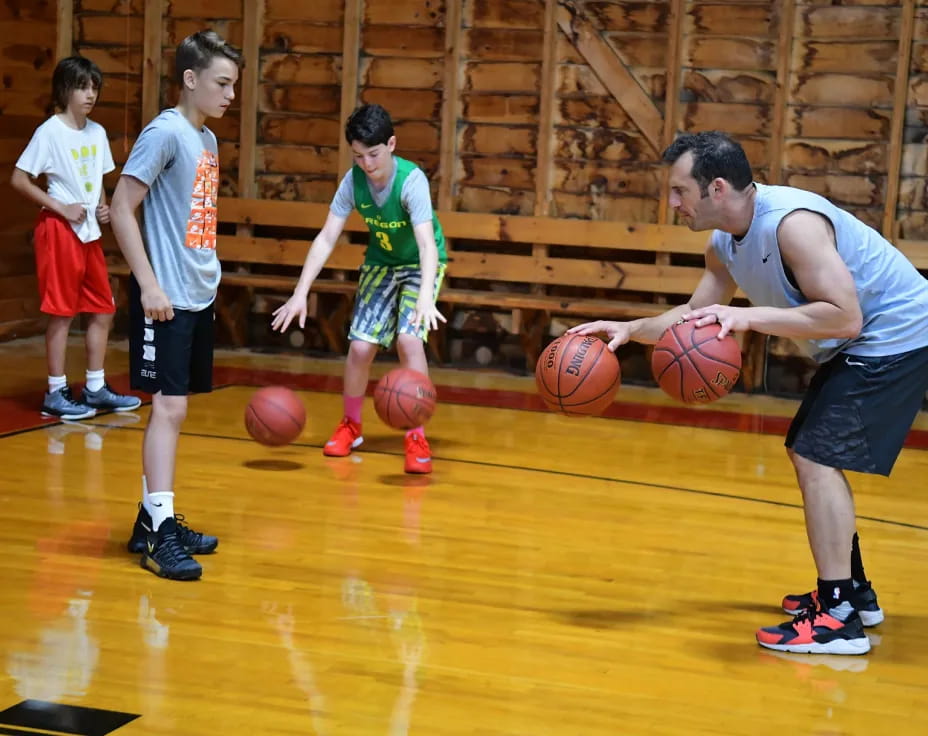 a group of kids playing basketball