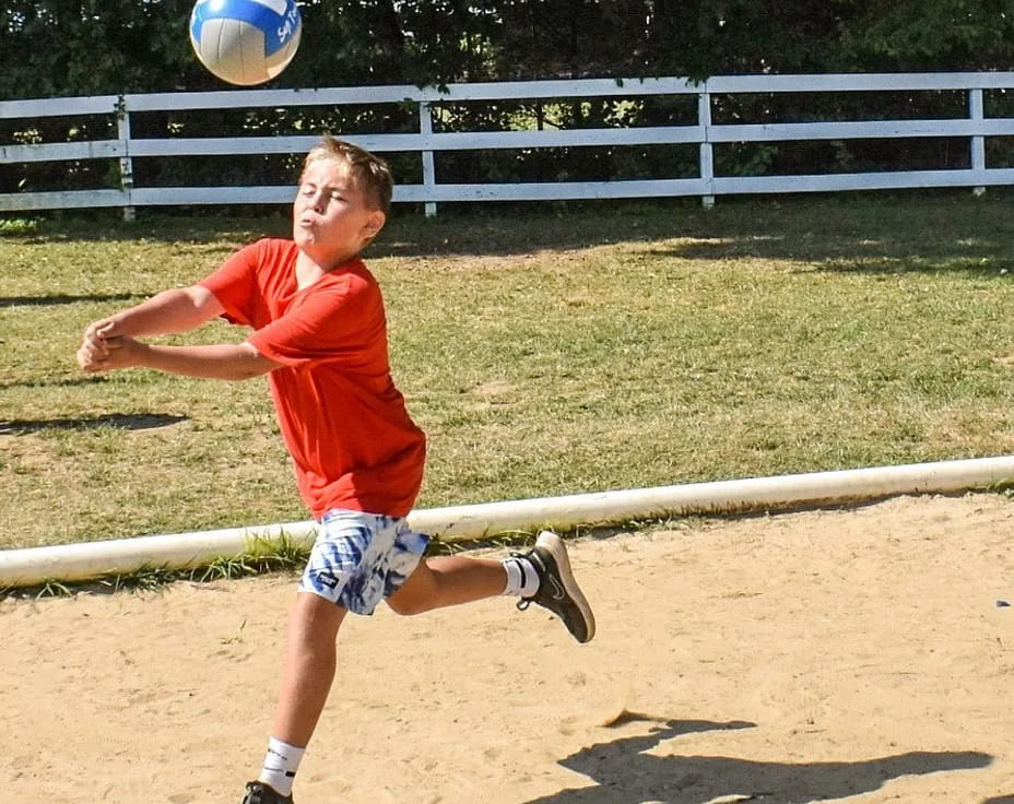 a boy playing with a ball