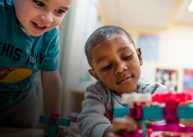 a couple of young boys playing with toys
