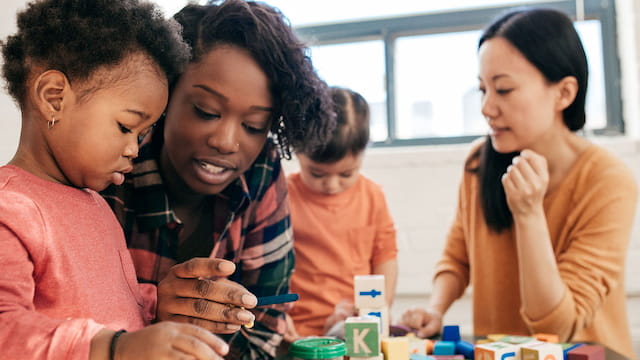 a group of children looking at a book