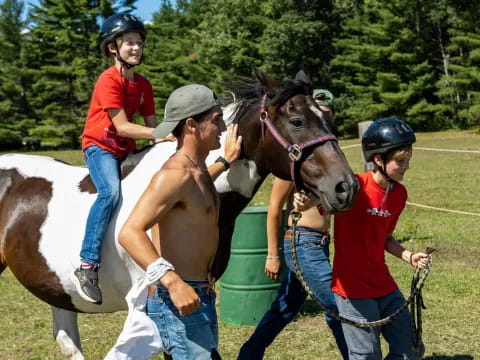 a group of people with a horse