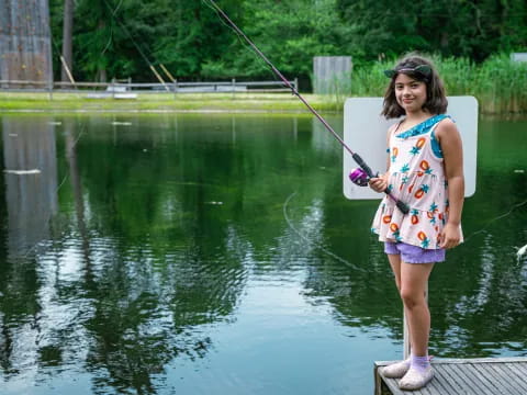 a girl holding a fishing pole