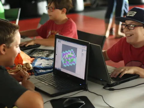 a group of boys using laptops