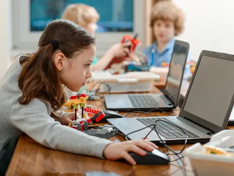 a young girl using a computer
