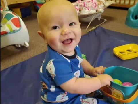 a baby sitting on a blue chair
