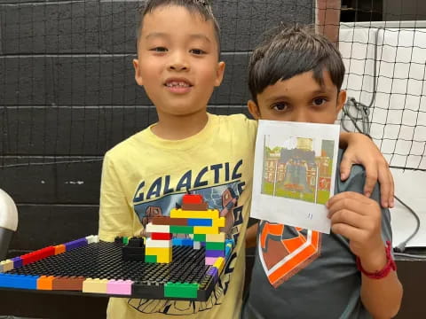 two boys holding a book