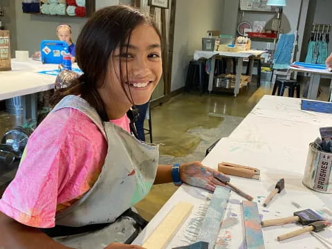 a woman painting on a table
