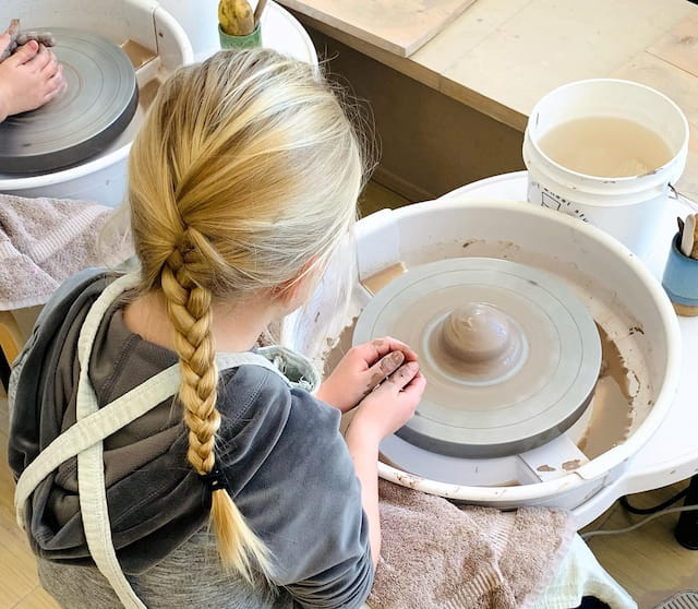 a person holding a white cup