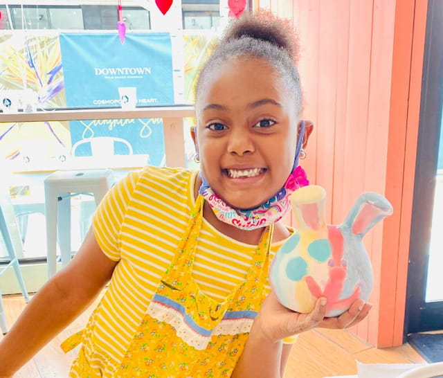 a girl holding a toy