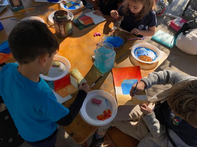 children painting on a table