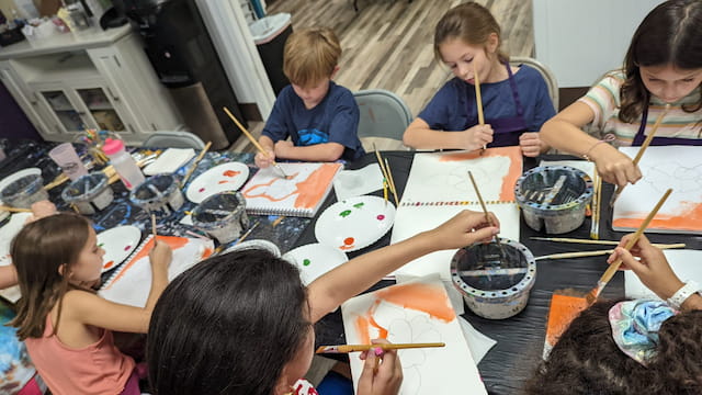 a group of children painting