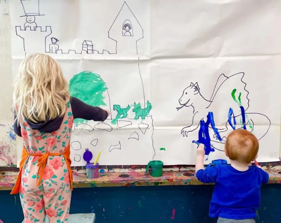 children painting on a white board