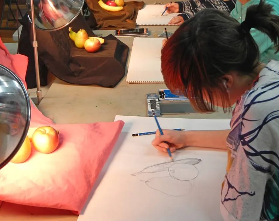 a person drawing on a paper