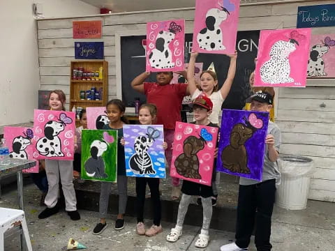 a group of kids holding signs