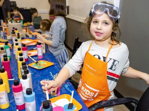 a young girl painting on a table