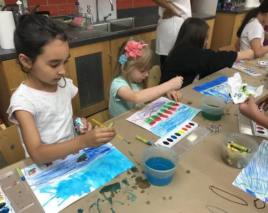 a group of children painting