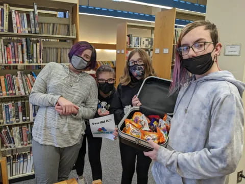 a group of people holding a box