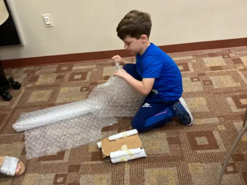 a boy sitting on the floor