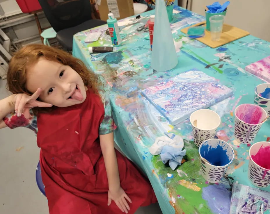 a girl sitting at a table