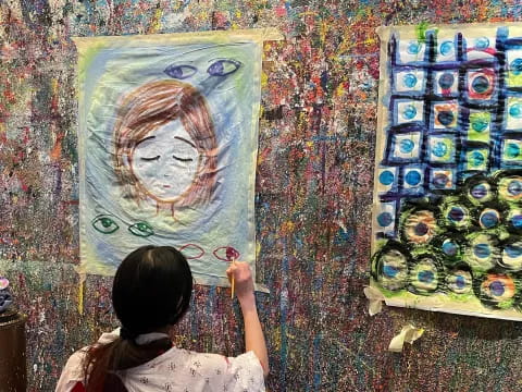 a girl painting on a wall