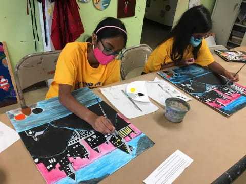 a couple of girls painting