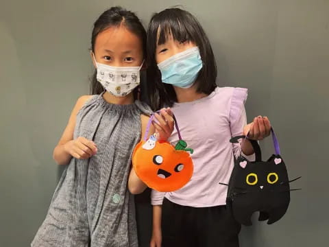 two girls wearing masks