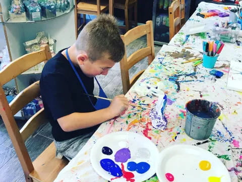 a boy painting on a table