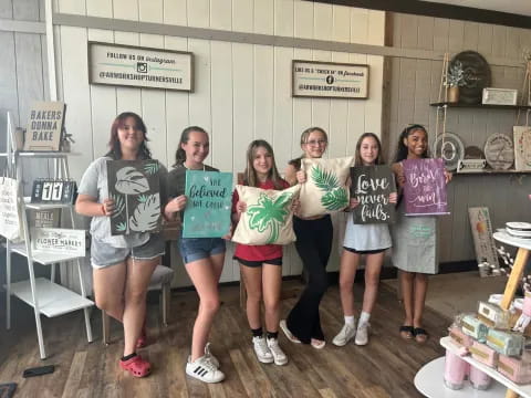 a group of girls holding signs