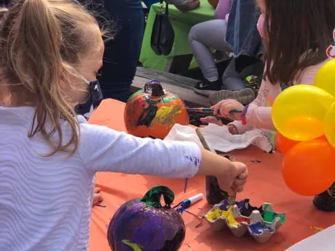 a woman and a child painting