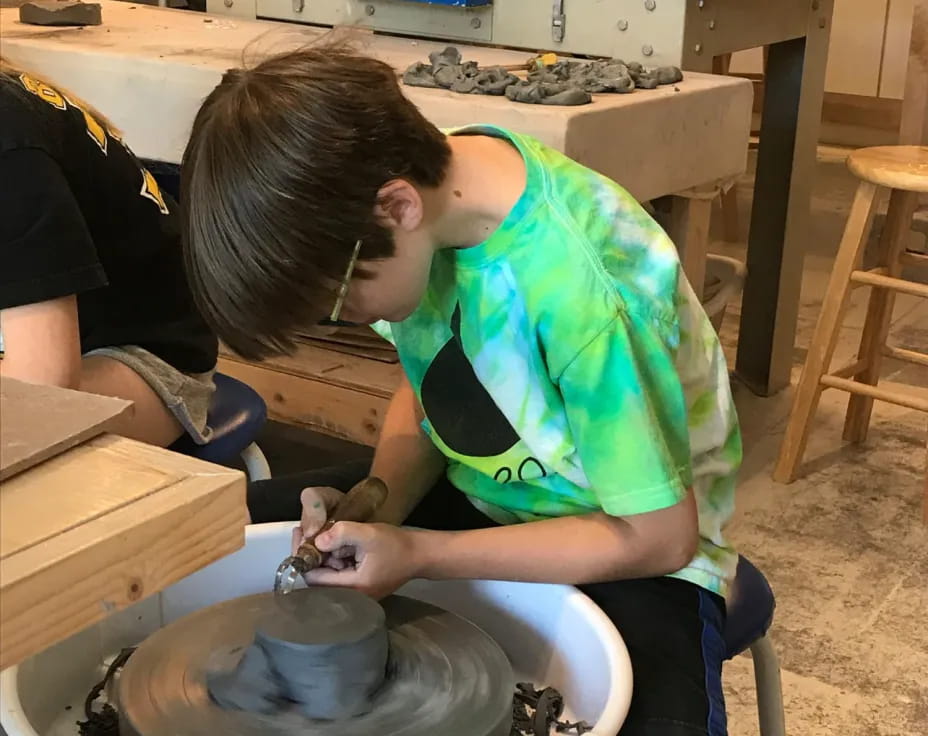 a person pouring liquid into a pot