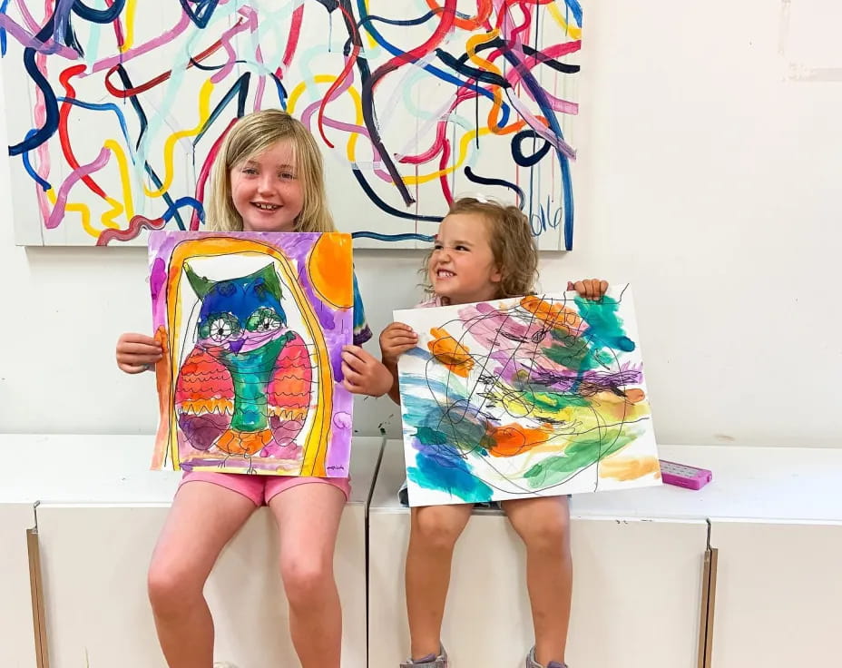 two girls sitting on a bench
