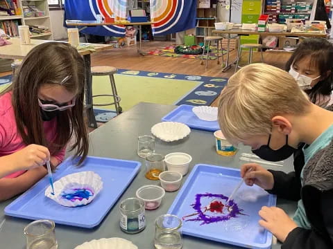 a group of children painting