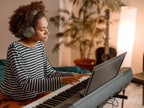 a woman playing a piano