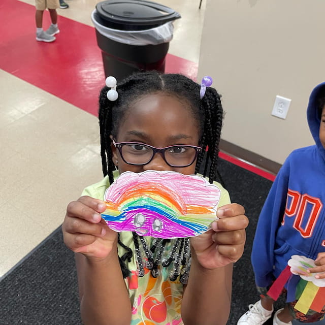 a girl holding a cupcake