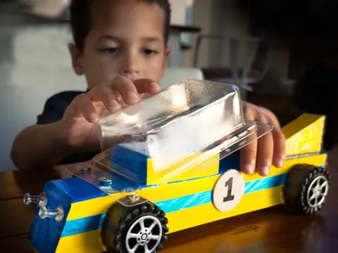 a child playing with a toy train
