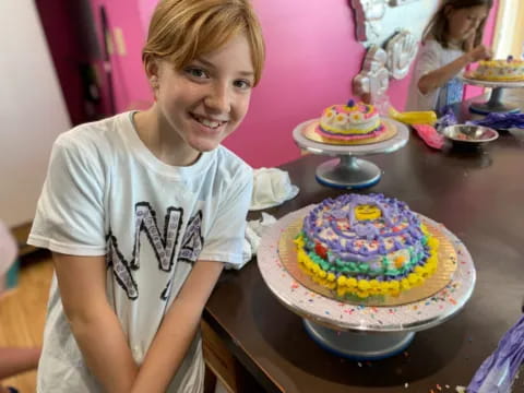 a person smiling next to a cake