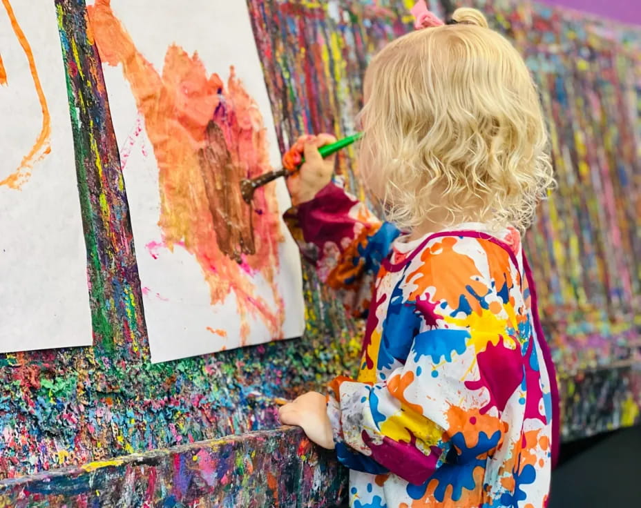 a child painting on a wall