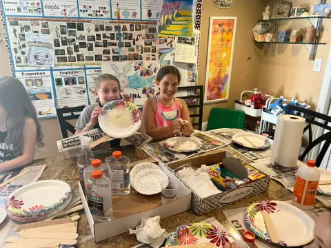 a couple of kids eating cake