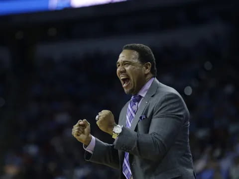 a man in a suit laughing