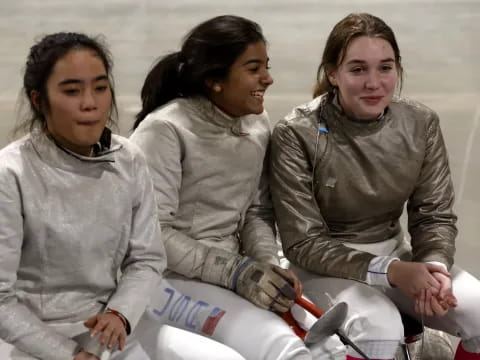 a group of women in white coats