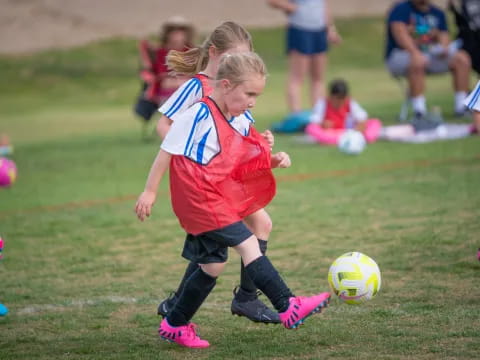 girls playing football on a field