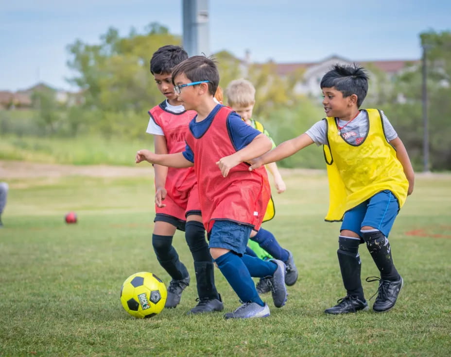 kids playing football on a field