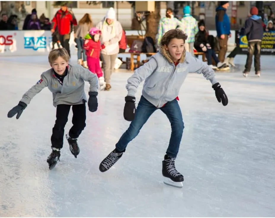 a couple of people ice skating