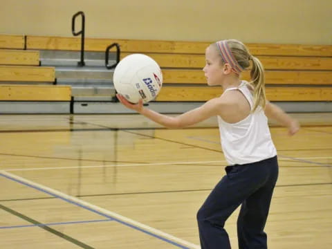 a girl holding a ball