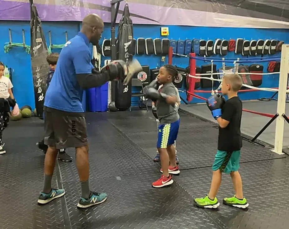 a person and kids in a gym