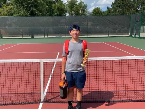 a boy holding a tennis racket