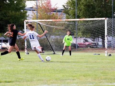 girls playing football on a field
