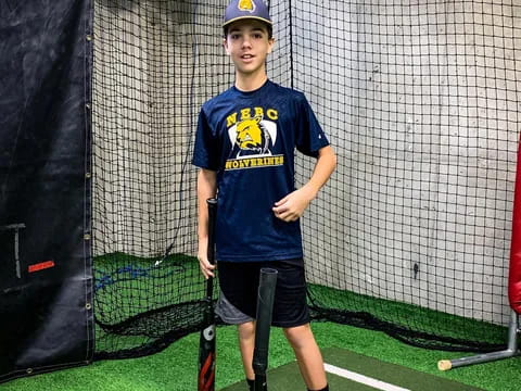 a boy holding a baseball bat